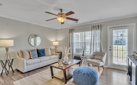 a living room with a couch and a ceiling fan